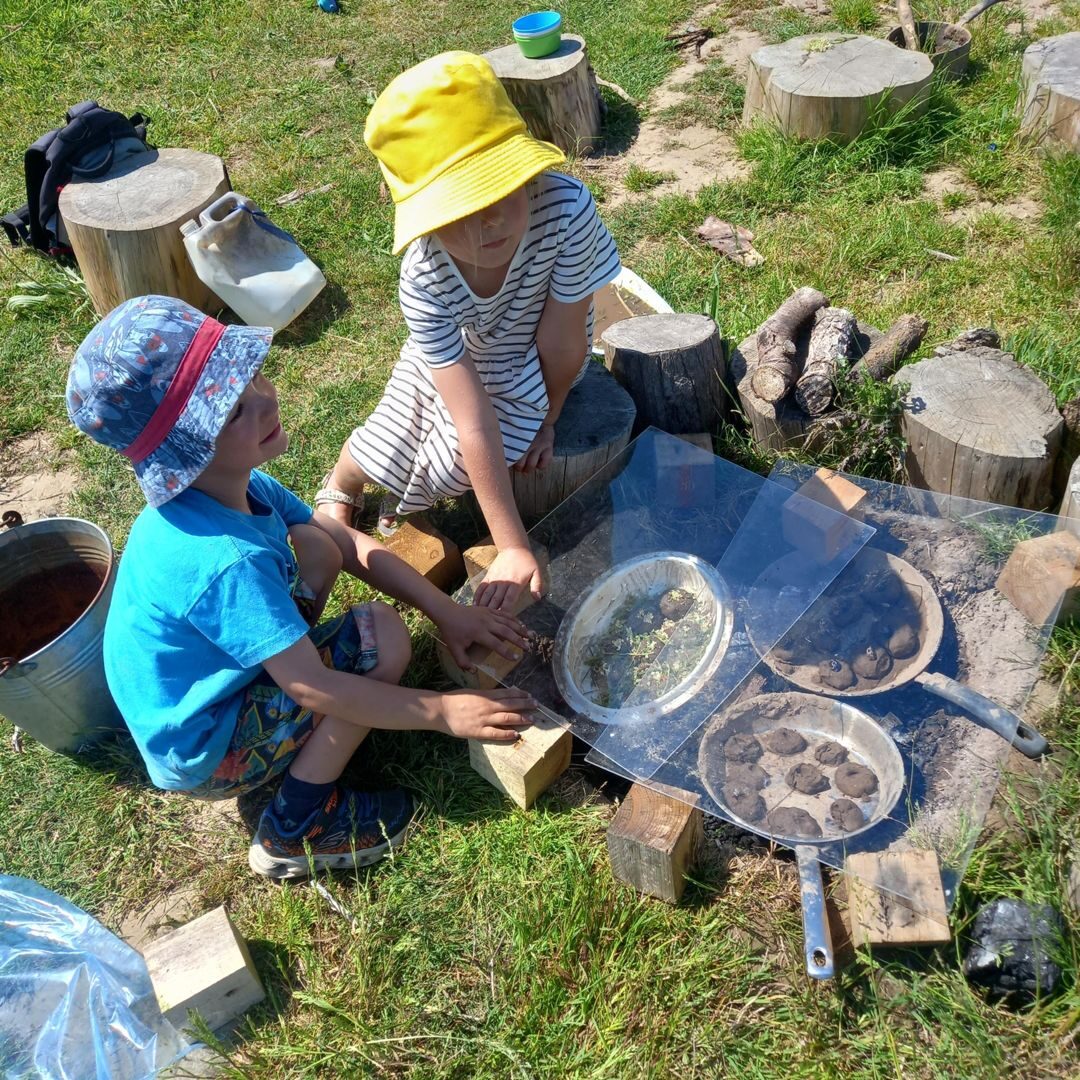 Children playing at the outdoor mud kitchen